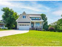 Charming two-story home featuring an attached two-car garage and landscaped front yard at 102 Starmount Dr, Kings Mountain, NC 28086