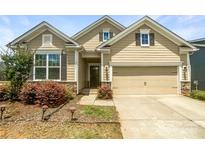 Charming home featuring a two-car garage, manicured landscaping, and stone accents at 103 Margo Ln, Statesville, NC 28677