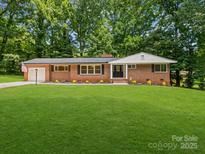 Charming brick home with a lush green lawn and beautiful landscaping at 1123 Timberlane Dr, Lincolnton, NC 28092