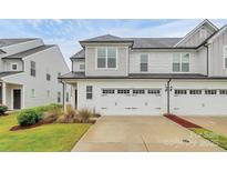 Charming two-story home with a two car garage, beautiful lawn, and classic white siding at 13022 Rover St, Charlotte, NC 28273