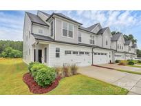 Charming home with white exterior, dark roof, and three-car garage at 13022 Rover St, Charlotte, NC 28273