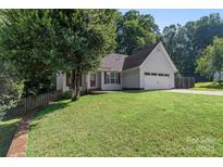 Charming one-story home featuring a well-maintained lawn and attached two-car garage at 131 Canopy Ct, Mooresville, NC 28115