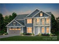 Charming two-story home with blue siding, covered porch and manicured lawn, perfect for suburban living at 13928 Penbury Ln # 399, Charlotte, NC 28278