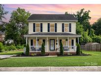 Charming two-story home with a welcoming front porch and well-manicured lawn at 1912 Baxter St, Charlotte, NC 28204