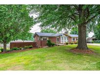 Charming brick home with well-maintained lawn and mature trees, offering great curb appeal at 2836 20Th Street Ne Ln, Hickory, NC 28601