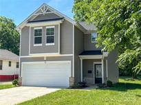 Charming two-story home with a well-maintained lawn and attached garage in a residential neighborhood at 414 1St Avenue Se None, Hickory, NC 28602