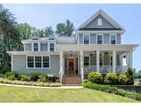 Charming two-story home featuring a welcoming front porch and landscaped front yard at 4237 Island Fox Ln, Denver, NC 28037