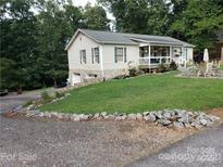 Charming home with a front porch, a well-maintained lawn, and a stone foundation at 5570 George Henry Dr, Hickory, NC 28602