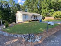 Charming single-story home with a well-maintained lawn, stone accents, and a welcoming front porch at 5570 George Henry Dr, Hickory, NC 28602