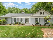 Charming single-story home featuring a welcoming front porch, well-maintained lawn, and manicured landscaping at 827 Ashwyn Dr, Charlotte, NC 28211