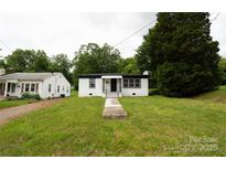 Charming single-story home with a well-maintained lawn and inviting front porch at 1017 W Fisher St, Salisbury, NC 28144
