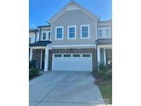 Attractive home featuring a two-car garage, neutral color palette, and architectural details at 10416 Audubon Ridge Dr # 4, Cornelius, NC 28031