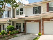 Charming townhome featuring a one-car garage, brick accents, and well-maintained landscaping at 146 Rapids Rd, Fort Mill, SC 29715