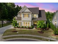Charming two-story home boasts a well-manicured lawn and inviting curb appeal with neutral colors and a warm, welcoming ambiance at 15103 Cimarron Hills Ln, Charlotte, NC 28278