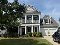 Charming two-story home with a welcoming front porch and a well-manicured lawn in a desirable neighborhood at 230 Yale Pl, Fort Mill, SC 29707