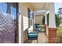 Charming covered front porch with seating, brick accents, and well-maintained exterior of the residence at 2614 Ocracoke St, Charlotte, NC 28208