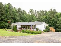 Charming single-story home with a covered front porch and lovely landscaping at 6213 Golden Oak Ln, Denver, NC 28037