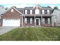 Charming brick home with a well-manicured lawn and attached two-car garage at 10615 Elm Bend Dr, Charlotte, NC 28273