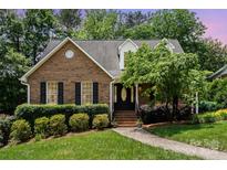 Charming brick home featuring manicured landscaping, a welcoming front door, and a well-maintained lawn at 139 Palaside Ne Dr, Concord, NC 28025