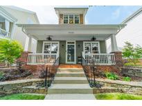 Charming two-story home featuring a covered porch, landscaped front yard, and inviting curb appeal at 14533 Holly Springs Dr, Huntersville, NC 28078