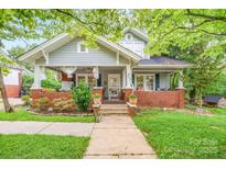 Charming home features a well-manicured front yard and inviting front porch at 153 S Center St, Taylorsville, NC 28681