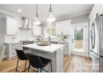 Bright kitchen features an island, stainless steel appliances, and shaker style cabinets at 2003 Ashley Rd # B, Charlotte, NC 28208
