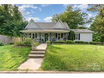 Charming home with a covered front porch, walkway and a well-manicured lawn at 300 S Hudson Ave, Spencer, NC 28159