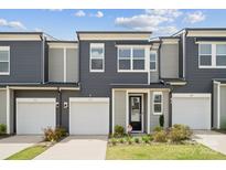 Charming townhome featuring a one car garage and tasteful two-tone exterior at 3115 Hutton Gardens Ln, Charlotte, NC 28269