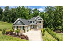 Stately two-story home with brick facade, well-manicured landscaping, and a spacious three-car driveway at 322 Ethan Ln, Rock Hill, SC 29732