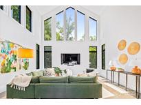 Bright living room with soaring ceilings, oversized windows, and comfortable seating with a modern aesthetic at 3304 Mar Vista Cir, Charlotte, NC 28209
