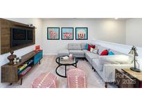 Cozy living room features comfortable seating, TV, and playful decor for a fun, relaxed atmosphere at 4368 Bronze Blvd, Sherrills Ford, NC 28673
