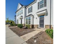 Charming two-story townhome featuring stone accents, well-manicured landscaping, and a welcoming entrance at 5008 Patton Dr, Gastonia, NC 28056