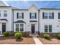 Charming townhome features light siding, dark shutters, manicured landscaping, and welcoming front entrance at 5008 Patton Dr, Gastonia, NC 28056