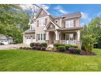 Charming two-story home with a welcoming front porch and well-manicured lawn, perfect for curb appeal at 501 Preservation Dr, Fort Mill, SC 29715