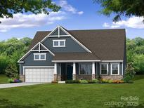 Charming craftsman-style home with blue siding, stone accents, a welcoming front porch, and a well-maintained lawn at 5205 Raging Creek Dr # 122, Indian Trail, NC 28079