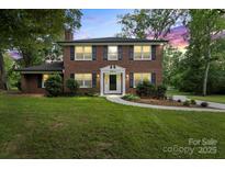 Charming two-story brick home with a manicured lawn and classic black shutters and trim at 5811 Gettysburg Dr, Concord, NC 28027