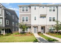 Charming townhome with stone accents, manicured lawn and a welcoming walkway to the front door at 7012 Bryce Ave, Charlotte, NC 28217