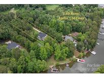 A beautiful aerial view showcasing the approximate lot lines and lake access with dock at 8283 Long Island Rd, Catawba, NC 28609