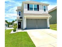 Charming two-story home with a two-car garage and well-maintained front lawn at 1207 Skyflower Way, Charlotte, NC 28214