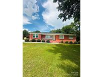 Charming red brick home with a well-maintained lawn, offering classic curb appeal at 1535 Jordan St, Lancaster, SC 29720