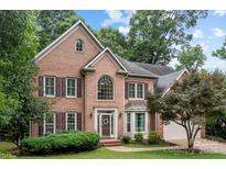 Charming brick two-story home with landscaped front yard and attached two-car garage at 17433 Glassfield Dr, Huntersville, NC 28078