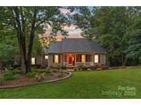 Charming single-story home featuring a well-manicured lawn, mature trees, and a welcoming front porch at 1912 Dawnhurst Ln, York, SC 29745