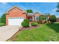 Charming brick home boasts a well-manicured lawn, attached garage, and inviting front entrance at 2079 Audubon Dr, Rock Hill, SC 29732