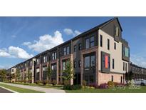 Modern townhomes with brick and siding accents, well-manicured lawns, and professional landscaping at 2158 N Graham St # 14, Charlotte, NC 28206