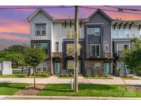 Charming townhome with a modern design, brick accents, and well-manicured landscaping at 223 S Bruns Ave, Charlotte, NC 28208