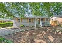 Charming single-story home featuring a welcoming front porch and wood-toned shutters at 3020 Stancill Pl, Charlotte, NC 28205