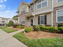 Charming townhouse featuring stone accents, well-maintained landscaping and a inviting entrance at 4607 Silk Tree Ln, Rock Hill, SC 29732