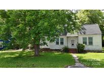 Quaint home featuring a well-maintained lawn and mature trees providing shade and curb appeal at 514 Saluda Rd, Chester, SC 29706