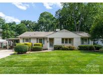 Charming single-story home with landscaped yard, carport, and inviting front entrance at 5533 Murrayhill Rd, Charlotte, NC 28210