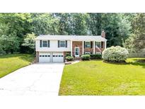 Charming two-story home with a well-maintained lawn, attached two car garage and inviting curb appeal at 5909 Ryder Ave, Charlotte, NC 28226